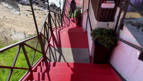 Young-man-moving-ahead-of-the-camera-going-down-the-stairs