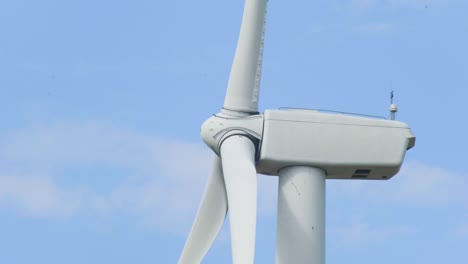 Wind-turbine-generator-close-up-clean-sustainable-renewable-energy-against-blue-sky