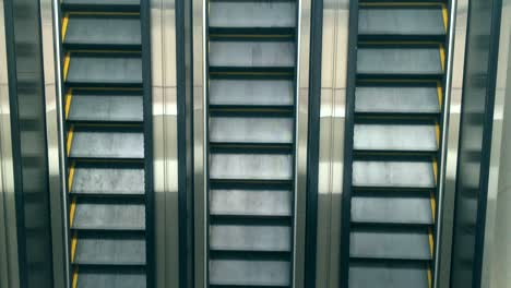 close-up shot of empty moving staircase running up and down. modern escalator stairs, which moves indoor.