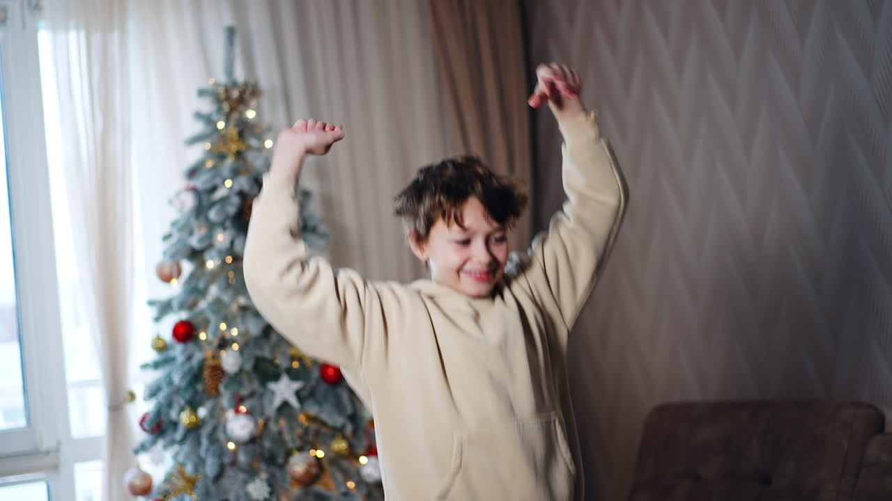 Happy Boy Dancing Near Christmas Tree