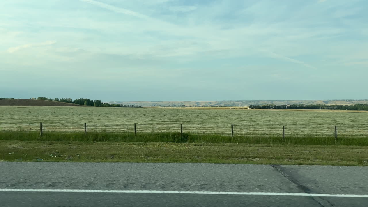 Real time dolly left shot of landscape seen during car trip around Banff, Canada. Passenger POV
