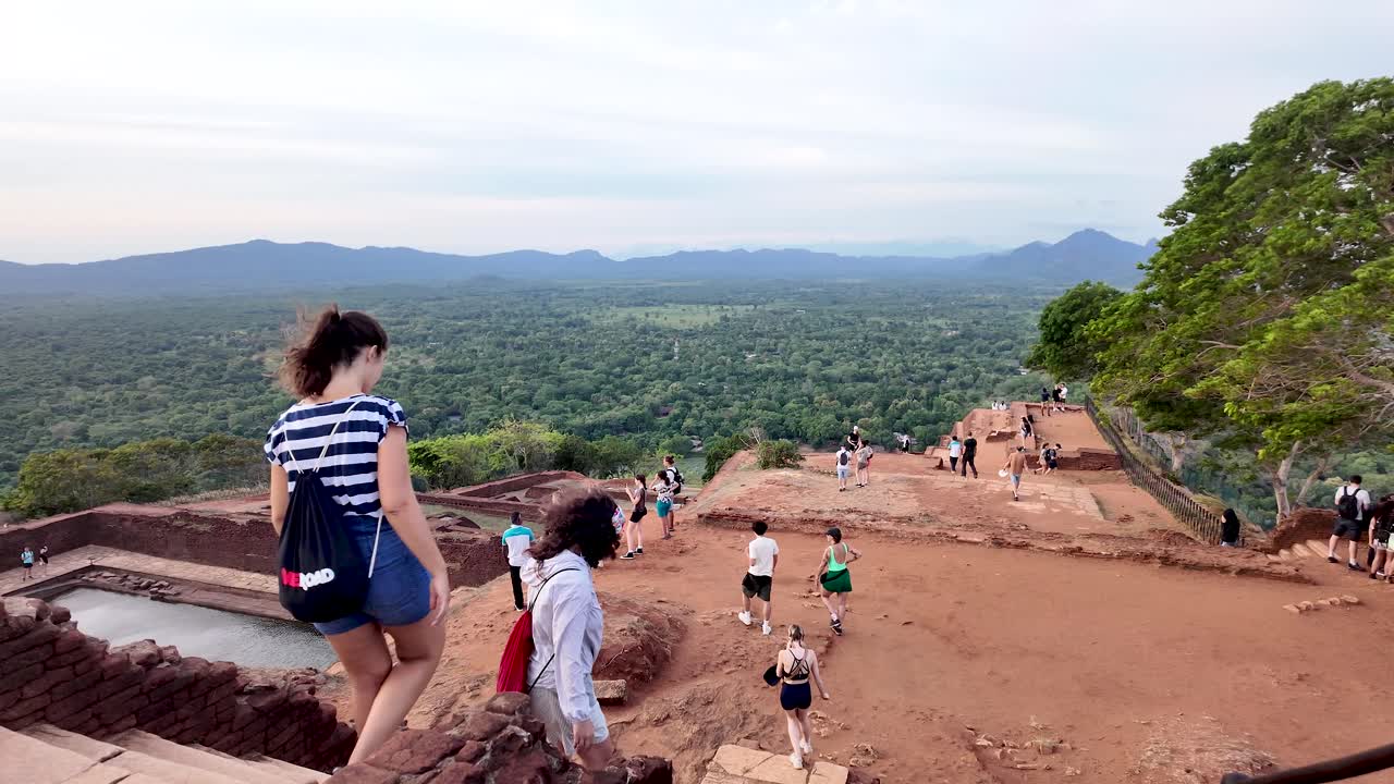 Visitors enjoy a scenic hike at Sigiriya Rock, an iconic landmark in Sri Lanka. slow motion shot
