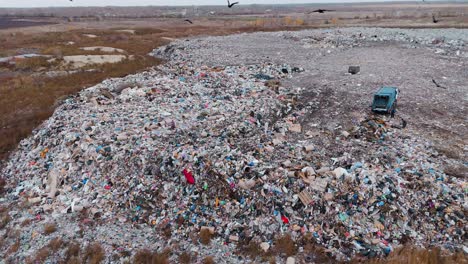 large landfill with garbage truck