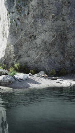 a calm and peaceful landscape with a cliff, lake, and mountains