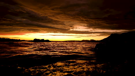 Abstract-vibrant-sunset---liquid-gold-ocean-surface-with-illuminated-cloudscape