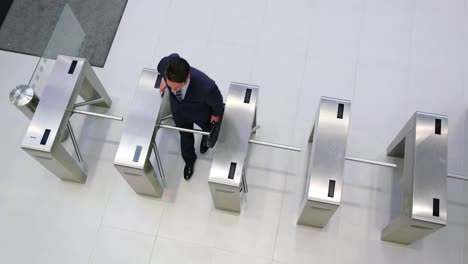 Businessman-scanning-their-cards-at-turnstile-gate