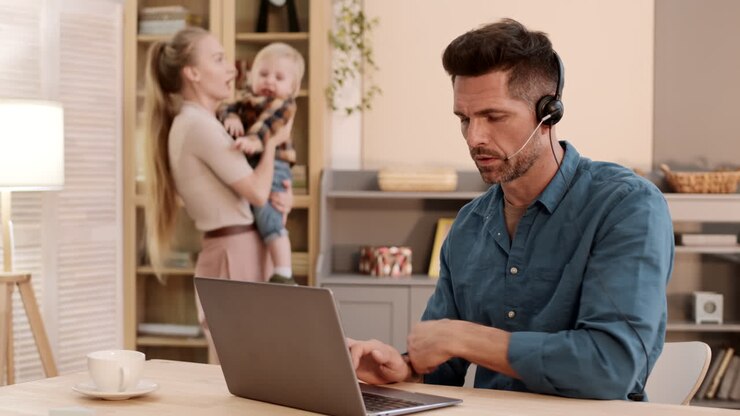 Man Working in Noisy Living Room
