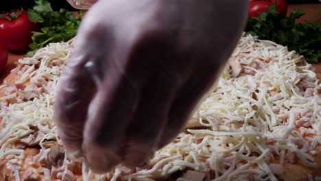 making a pizza with cheese and mushrooms