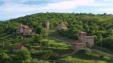 aerial view of srediste monastery with the green mountain in banat, serbia