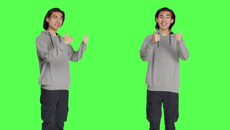 asian guy gives thumbs up in studio