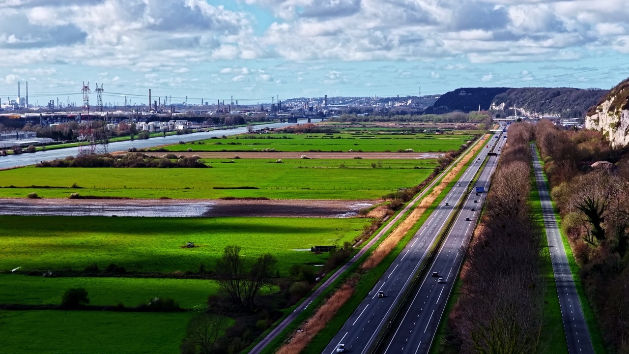 Highway Along Lush Green Fields Near Seine River In Le Havre, France. high angle, static shot