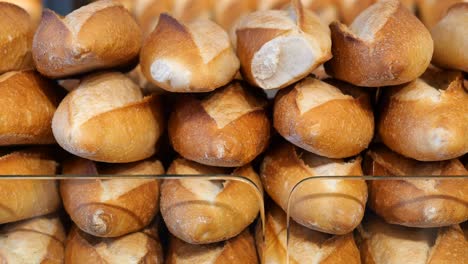 fresh baguettes stacked in a bakery