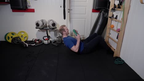 weighted rib wall sit-ups, intense ab training for man in home gym