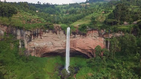 Aerial view of Sipi Falls cascading from rugged cliffs into dense vegetation on the slopes of Mount Elgon near Kapchorwa, showcasing the region's iconic geology and tropical environment