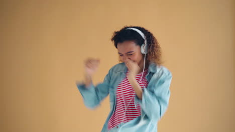 happy teen girl dancing with headphones