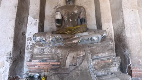 a weathered buddha statue in a historic temple