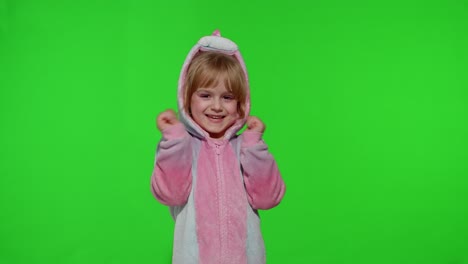 Little-blonde-child-girl-smiling,-dancing,-celebrating-in-unicorn-pajamas-costume-on-chroma-key