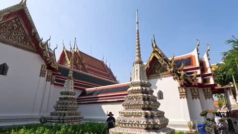 tourists admire pagodas at wat pho temple