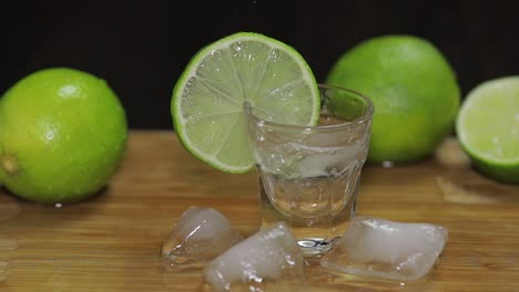 Pouring-vodka-or-tequila-into-shot-glasses-with-ice-cubes