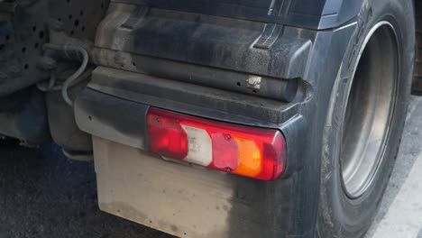 close-up of a truck's rear lights and tire