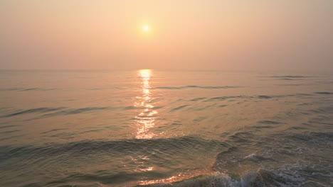 Tilt-up-on-a-colorful-sunset-over-the-incoming-tide