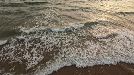 Relaxing-waves-roll-over-sandy-beach-of-Portugal,-aerial-view