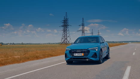 front view of a luxury car moving on the road in daylight. new electric car audi e-tron driving on the highway.