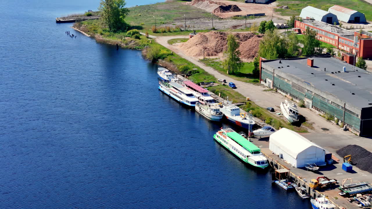 Overhead View Focusing on the Central Bridge and Deck of a Large Container Ship, Surrounded by Closely Packed Rows of Multi-Colored Shipping Containers in a Vast Industrial Port Terminal