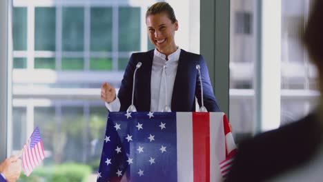 female speaker speaks in a political campaign seminar at modern office 4k