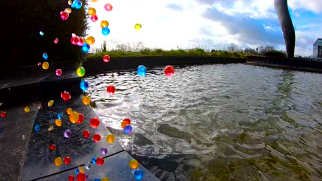 colorful bouncing balls at the edge of the fountain