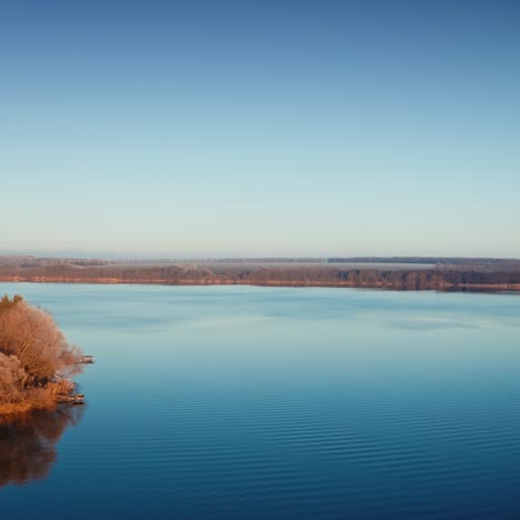 calm river at sunrise. winter landscape over the river. slight mist on trees near the river. amazing nature in the morning. aerial view.