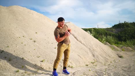 man doing outdoor workout in quarry