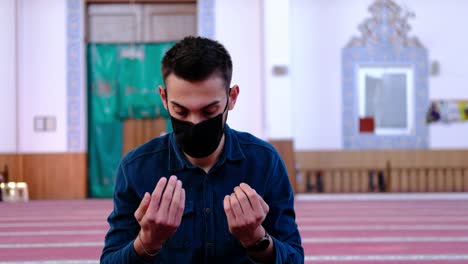 young muslim prays in mask due to covid19 2