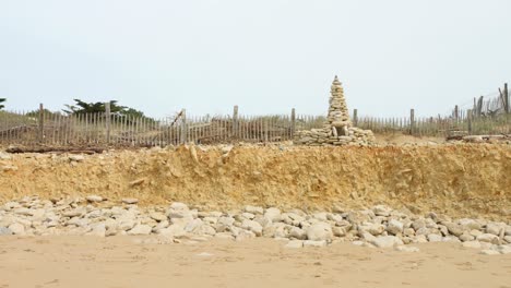 stones pyramid in sand dunes - wide shot