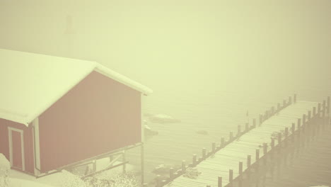 red house on snow covered norwegian pier
