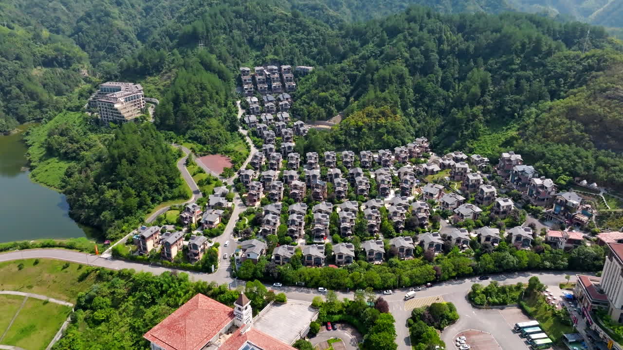 Aerial tracking shot in front of holiday village, vacation lodges, summer in China