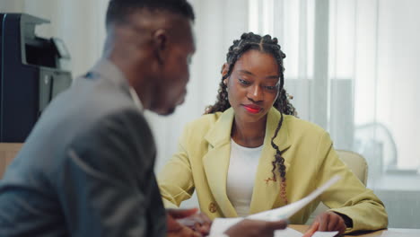 job interview and consultation with lawyer african american man and woman are discussing in office