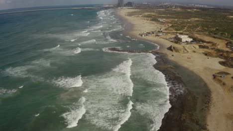 4k aerial - rocky coastline with crashing waves - north israel