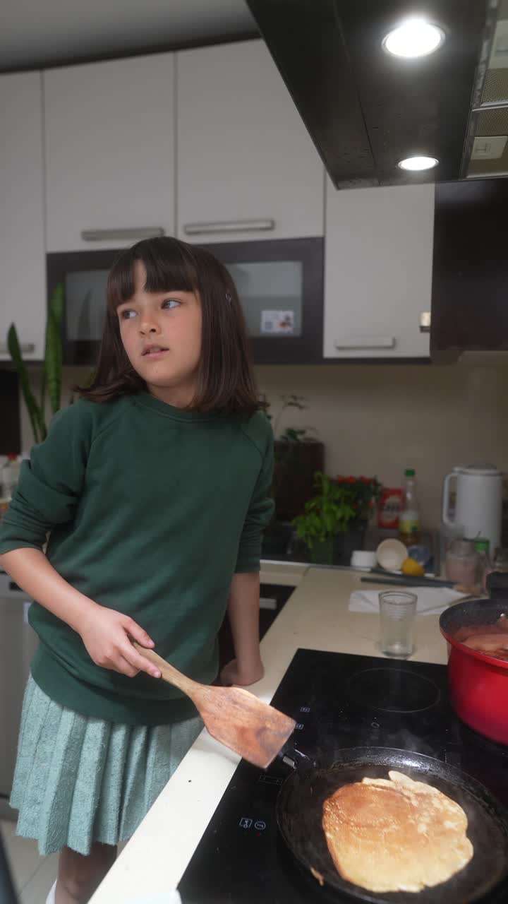 Girl Cooking Pancakes in the Kitchen