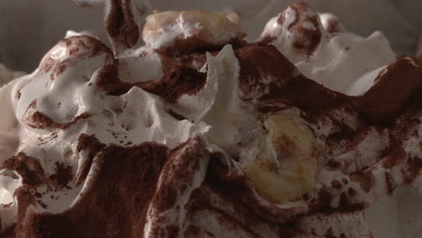 hands with colored spoons eating banana vanilla ice cream from an ice cream container, time lapse