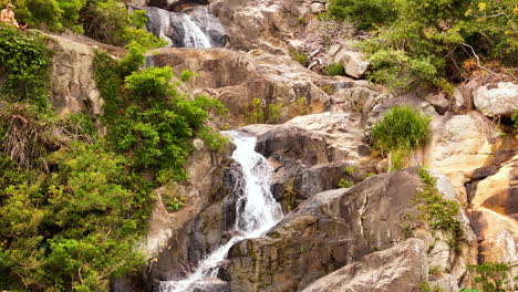 espectacular imágenes aéreas que ascienden a la cima de una cascada de cinco pisos que desciende por las tierras altas sagradas del pueblo raglai en las majestuosas selvas de nui chuan, ninh thuan, vietnam