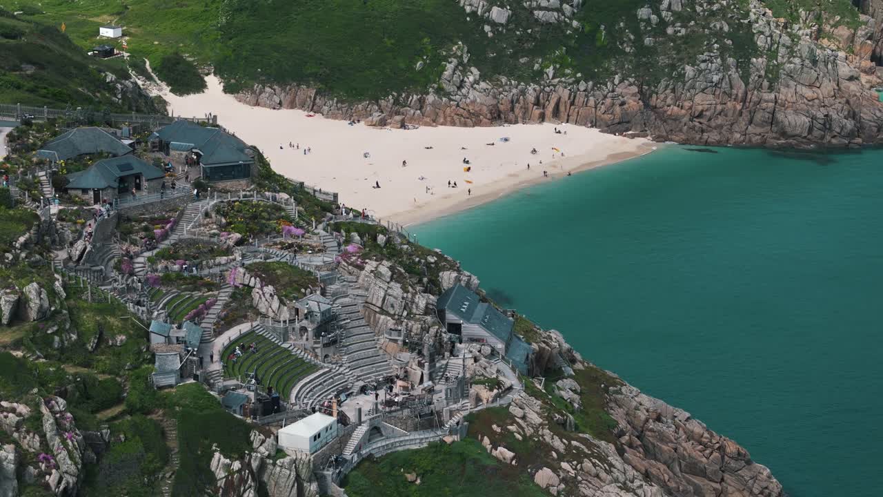 Aerial circling descent over Minack Theatre on Cornwall's clifftops