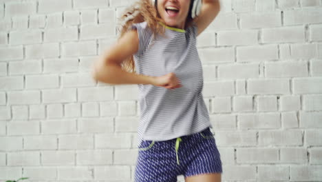 happy woman dancing in her bedroom