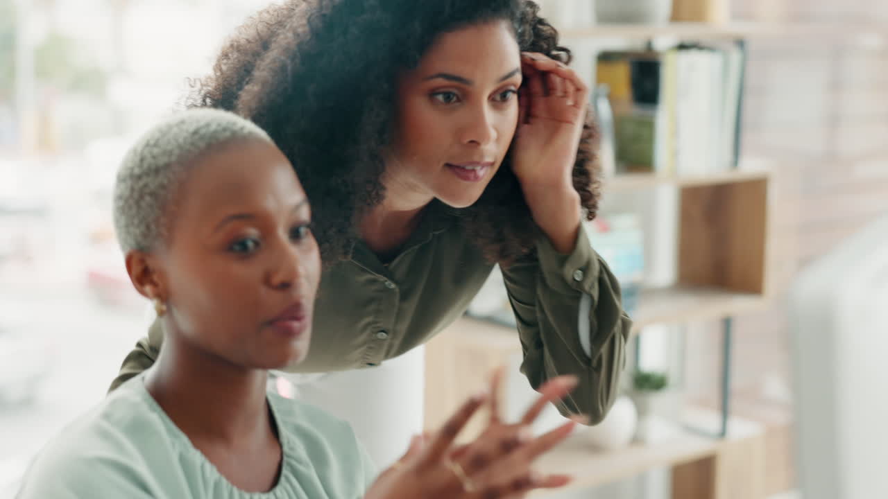 Women in office, with computer on desk talk