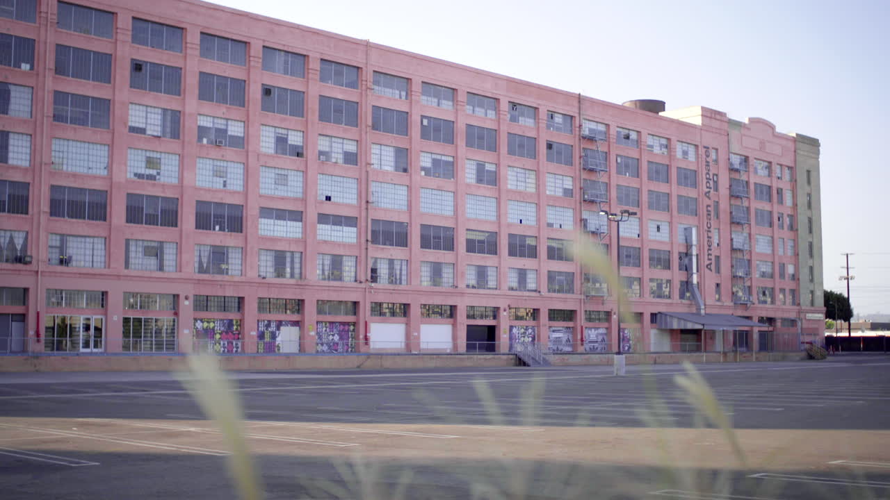 Pink Industrial Building with Empty Parking Lot