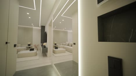 modern living room interior design and decoration with white sofa in living area, dining table and wooden chairs, kitchen counter and cabinets. 4k video 3d rendering apartment room with balcony