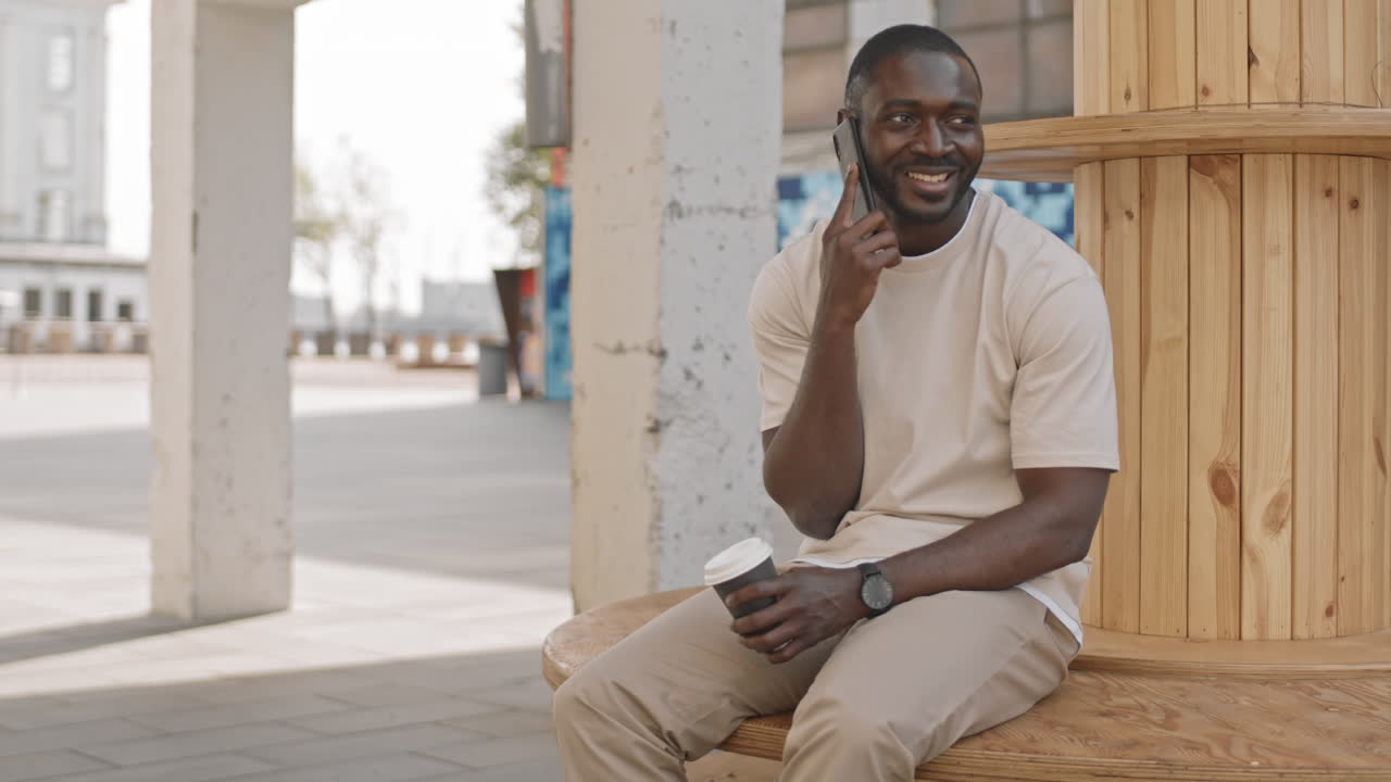 Afro American Man Smiling while Making Phone Call
