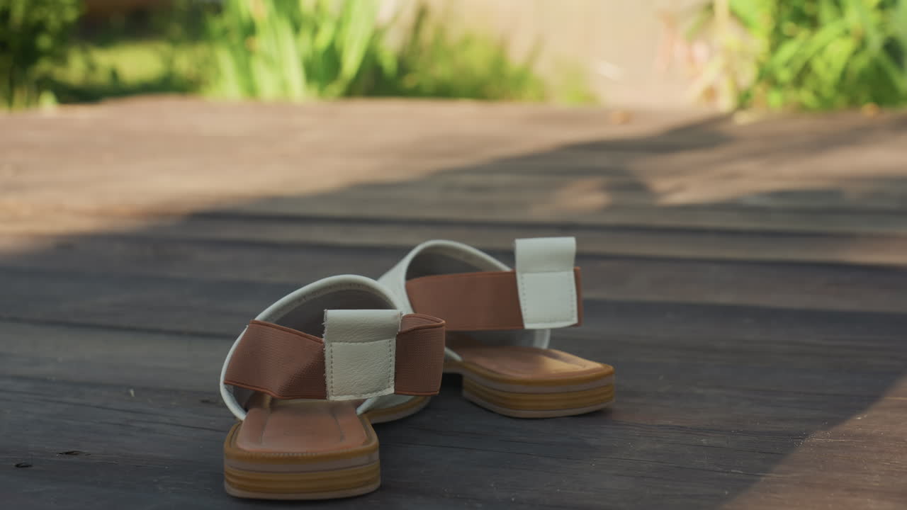 Fashion Sandals On Bright Sunlit Deck, Closeup Shot Of Stylish Sandals Against Soft Garden Background, Marketready Footwear Featuring Detailed Leather Straps And Warm Morning Sunlight Ambiance