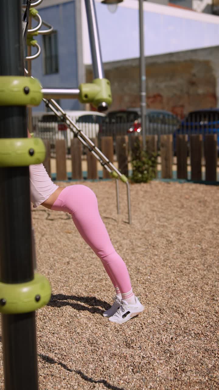 Woman working out at outdoor fitness park