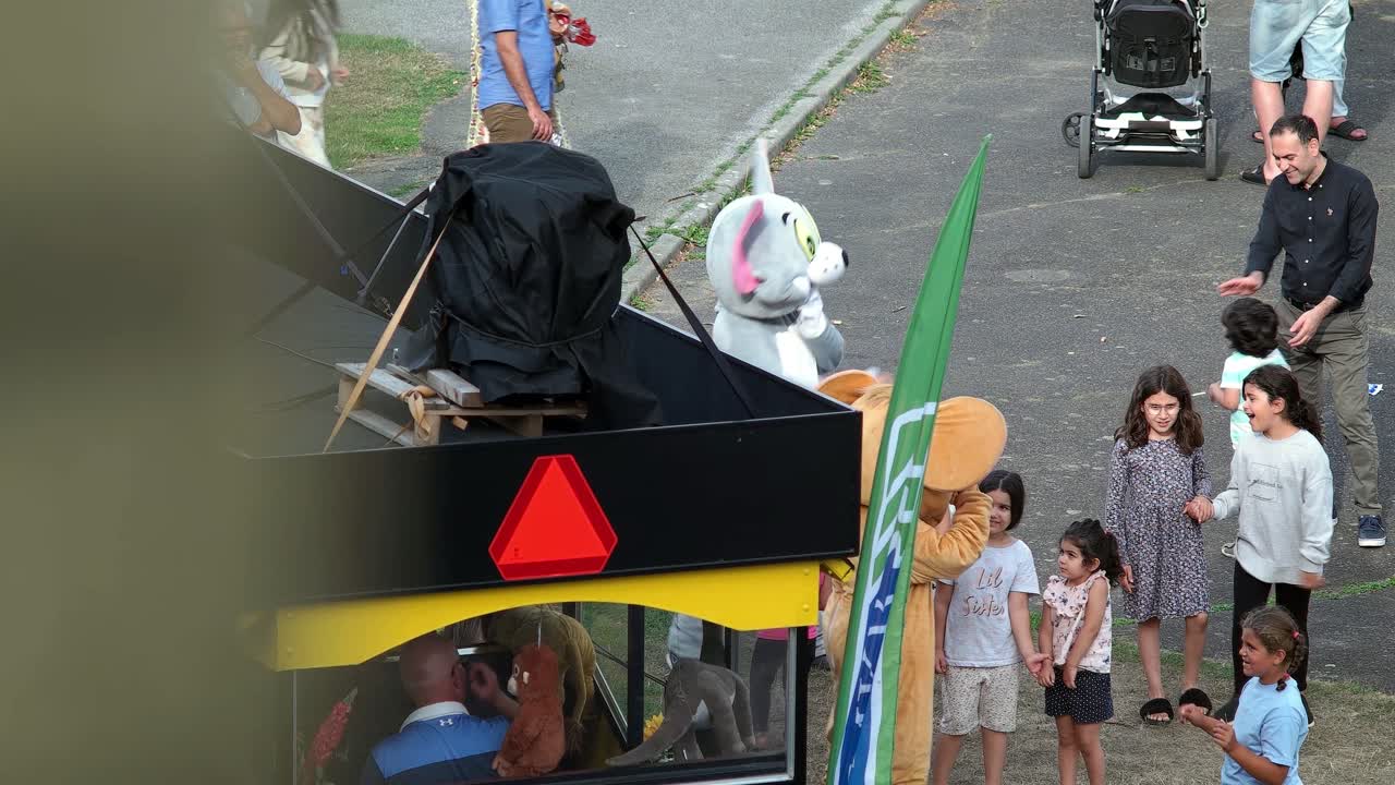 Migrant kids and Swedish kids playing in the park with a Panda in Malmo Sweden. Immigrant Area mixed with Swedish citizens. MKB housing agency organize music for kids during winter, summer, Christmas.